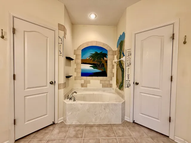 a bathroom with a tub and a shower