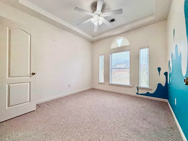 an empty room with windows and closet