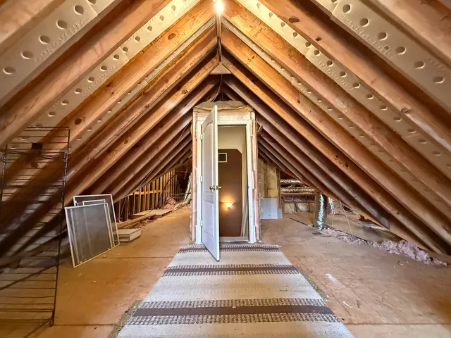 a backyard of a house with couches and wooden floor