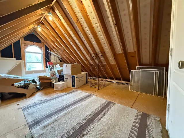 a view of walk in closet with clothes