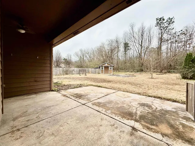 a view of a house with a yard covered in snow