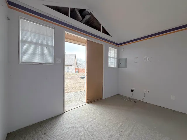 a front view of a house with yard and trees