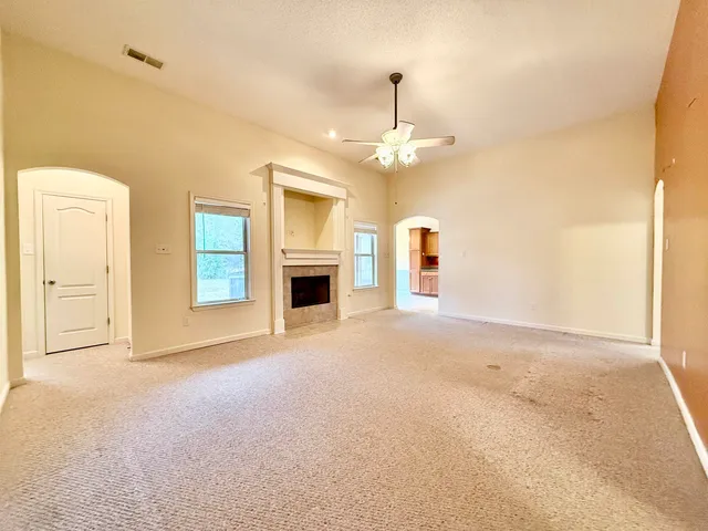 a view of an empty room with a fireplace