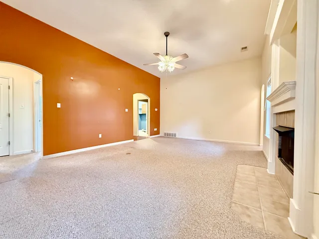 a view of an empty room with a fireplace