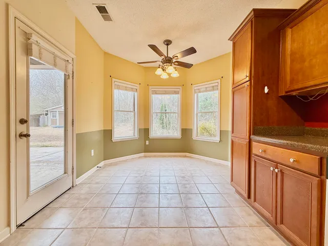 a view of an entryway with a chandelier fan