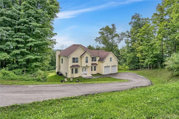 a front view of a house with a yard and garage