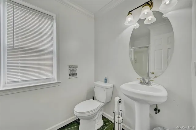 a bathroom with a sink toilet and a mirror
