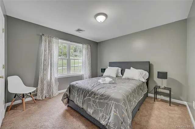 a bedroom with a bed a table and chair