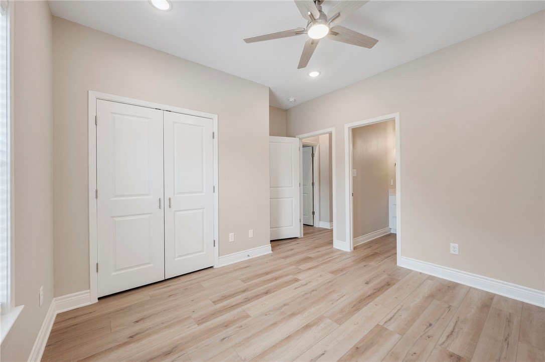 3213 Link Street, Unit 114 Bryan, TX 77801 - Photo 15 of 25 an empty room with wooden floor fan and windows