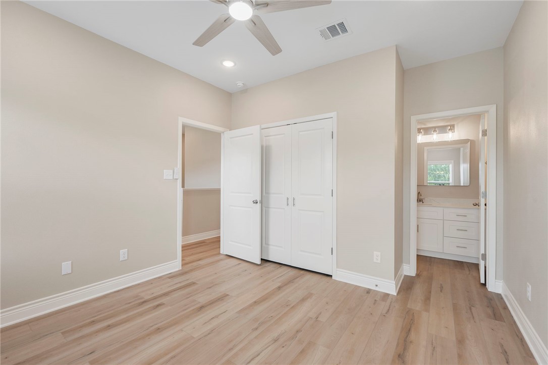 3213 Link Street, Unit 114 Bryan, TX 77801 - Photo 9 of 25 an empty room with wooden floor and ceiling fan