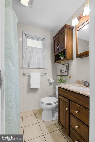 a bathroom with a granite countertop toilet sink and mirror