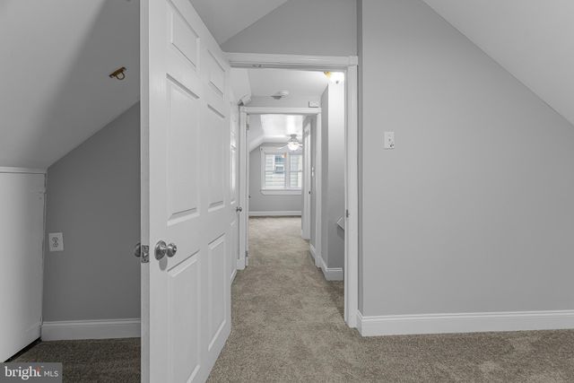 a view of a hallway with closet and wooden floor