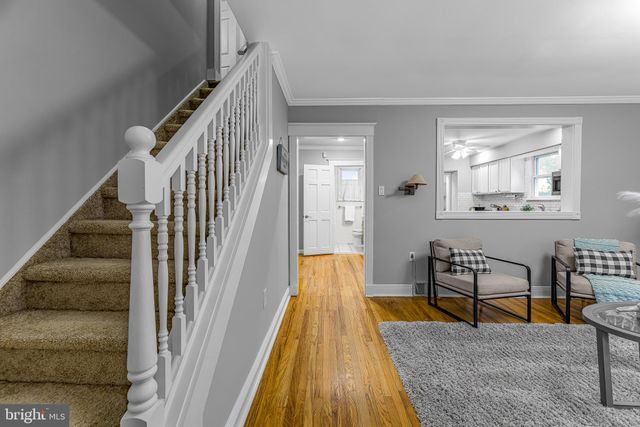 a view of a livingroom with furniture and stairs