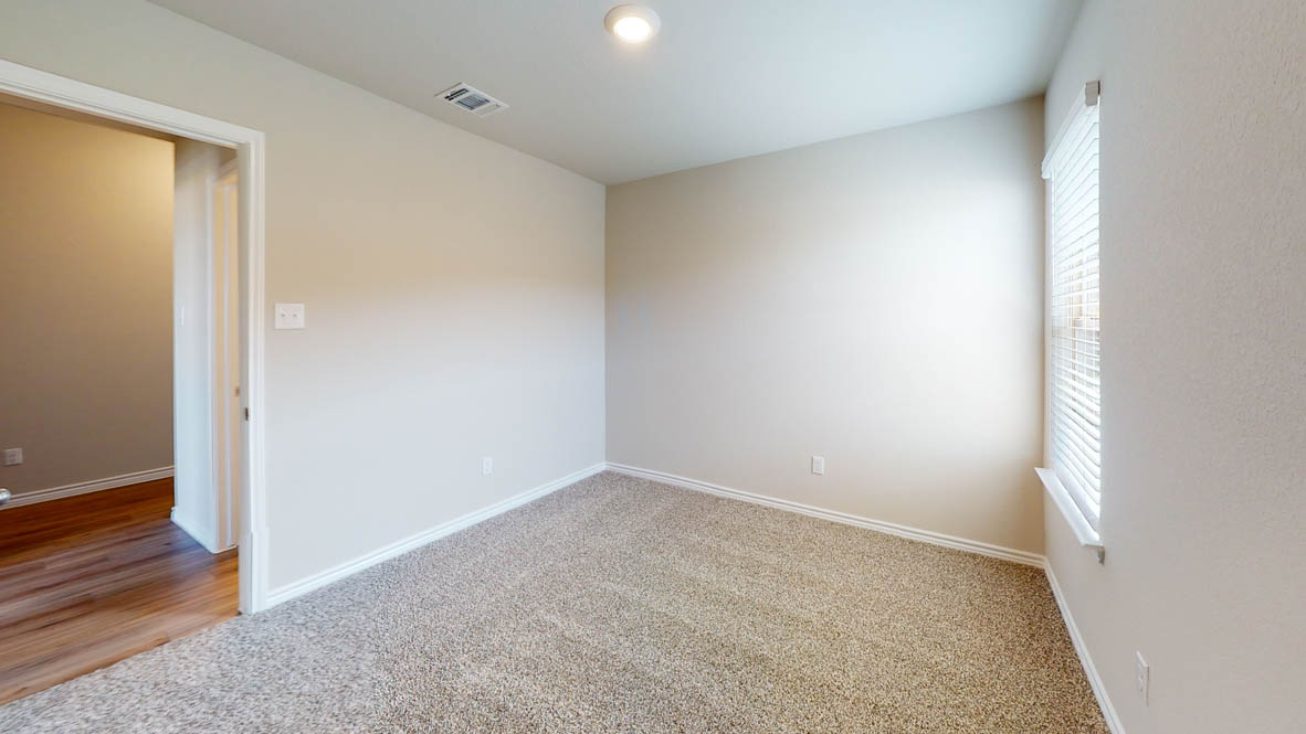 429 Creekfall Road Burnet, TX 78611 - Photo 23 of 28 A well-lit room offers a clean canvas for your personal touches, featuring soft carpeting and a clear window.