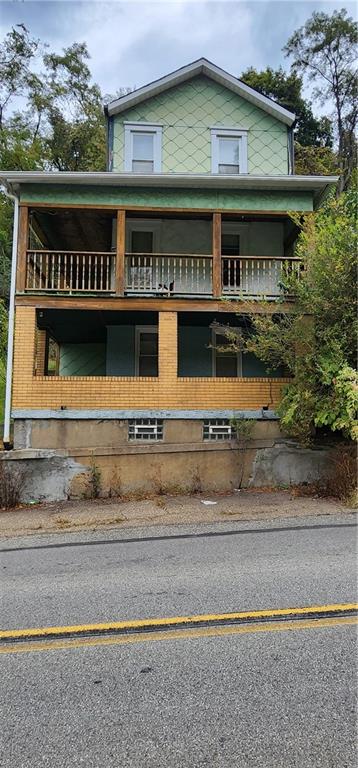 901 6th Street Braddock, PA 15104 - Photo 1 of 25 a front view of a house with a yard and garage