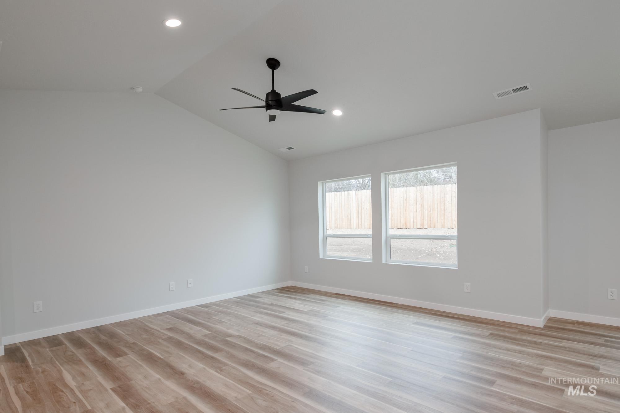 1576 Long Pond Street Middleton, ID 83644 - Photo 11 of 22 Unfurnished room with light wood-style flooring, vaulted ceiling, ceiling fan, and recessed lighting