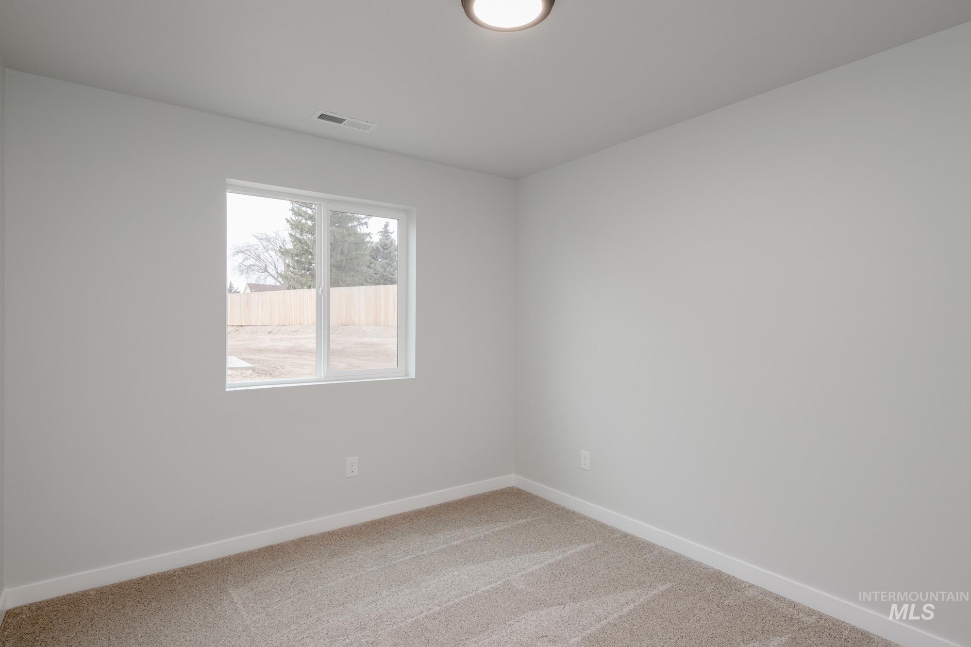 1576 Long Pond Street Middleton, ID 83644 - Photo 13 of 22 Carpeted spare room featuring baseboards