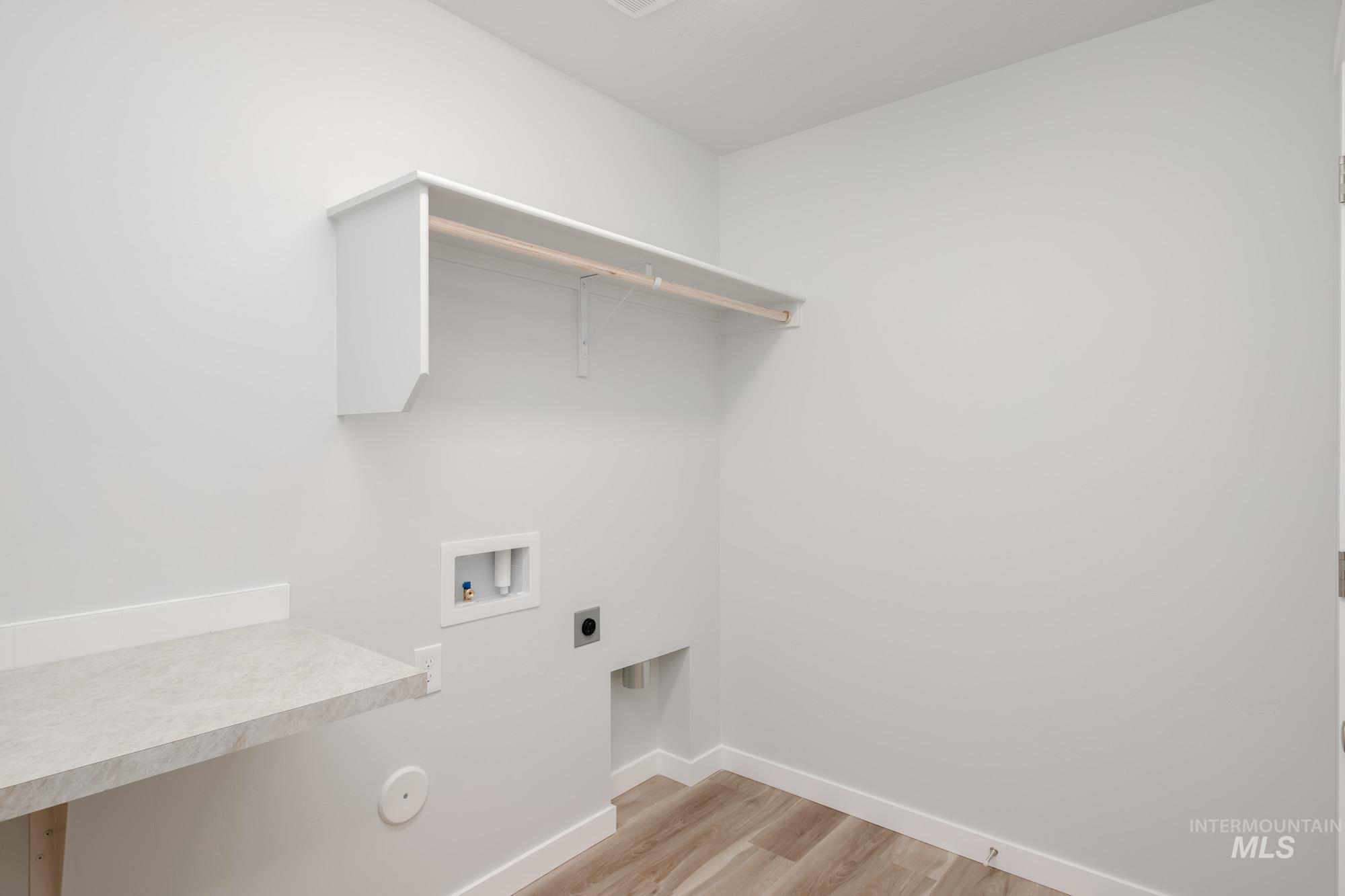 1576 Long Pond Street Middleton, ID 83644 - Photo 17 of 22 Washroom with light wood-type flooring, washer hookup, and electric dryer hookup