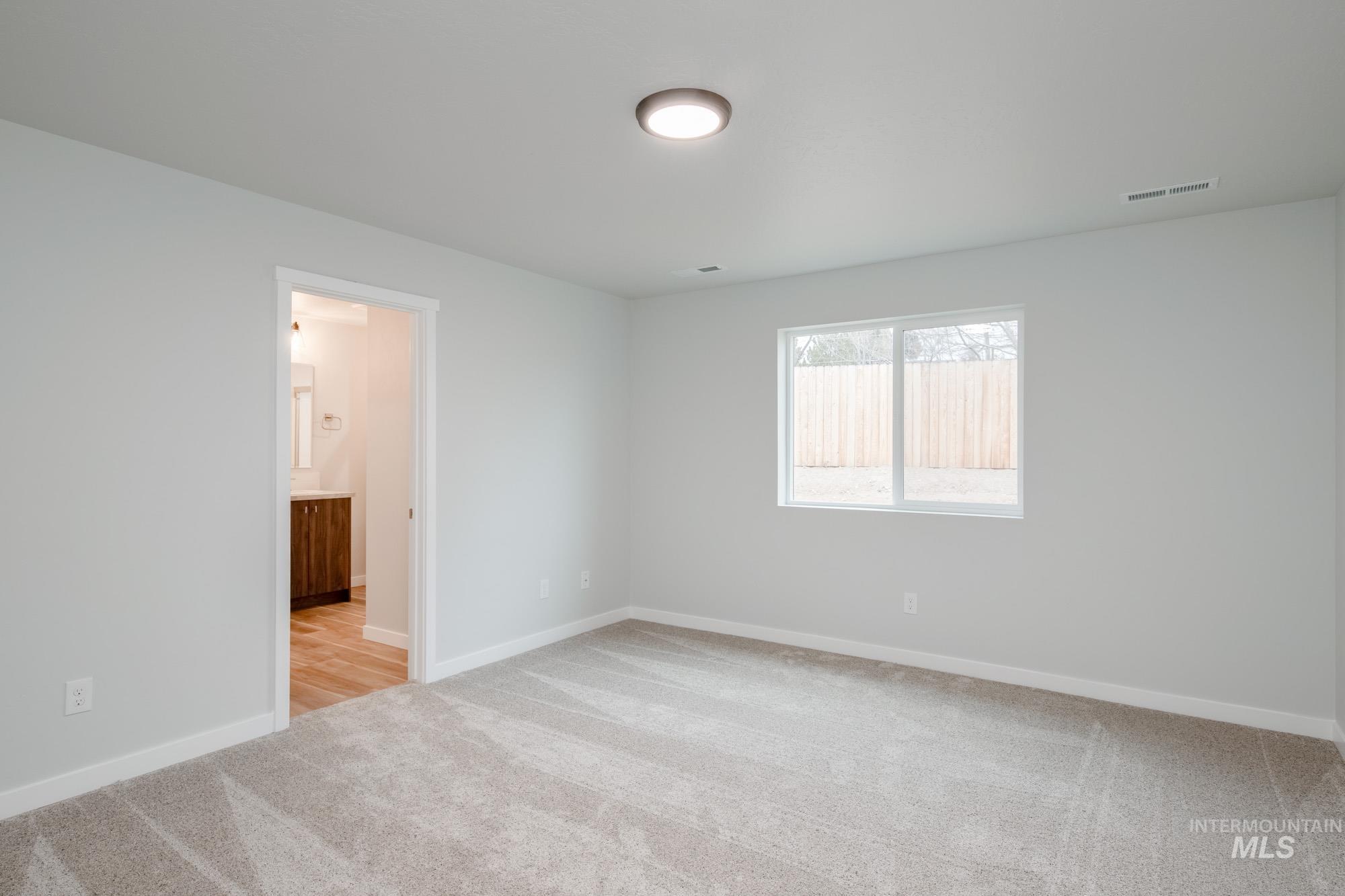 1576 Long Pond Street Middleton, ID 83644 - Photo 18 of 22 Empty room featuring light carpet and baseboards