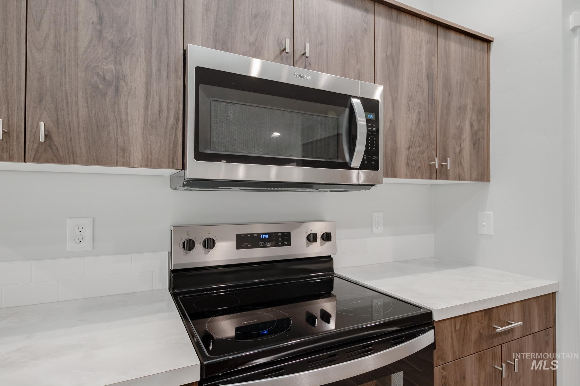 1576 Long Pond Street Middleton, ID 83644 - Photo 5 of 22 Kitchen with modern cabinets, appliances with stainless steel finishes, and brown cabinetry