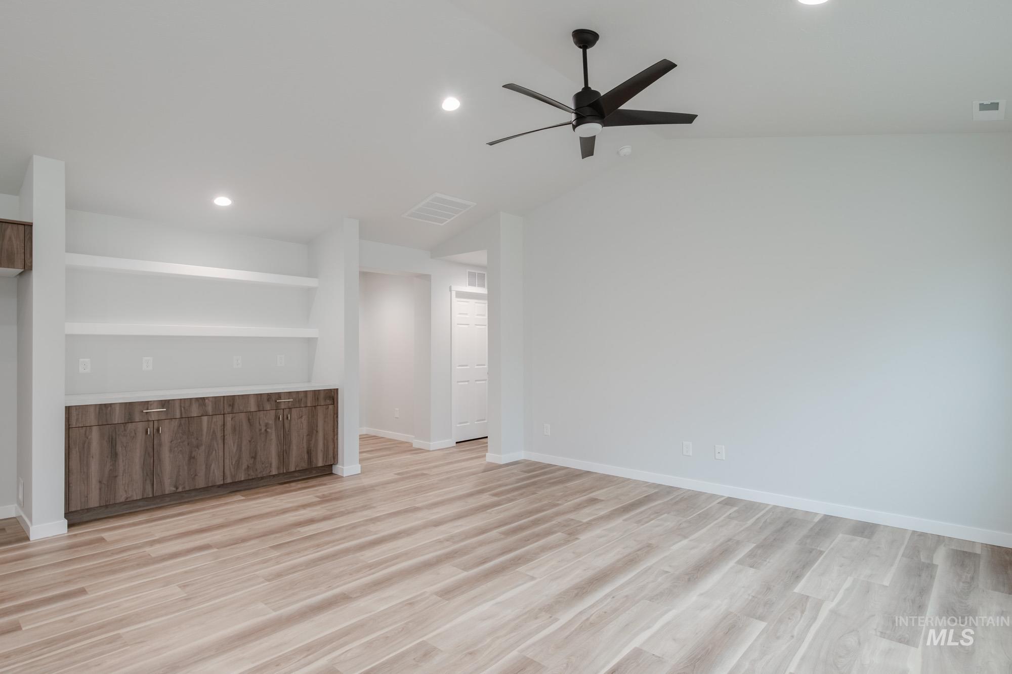 1576 Long Pond Street Middleton, ID 83644 - Photo 10 of 22 Unfurnished living room featuring light wood finished floors, recessed lighting, a ceiling fan, and vaulted ceiling