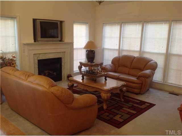 7129 Spanglers Spring Way Raleigh, NC 27610 - Photo 9 of 19 a living room with furniture and a fireplace