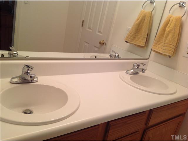 7129 Spanglers Spring Way Raleigh, NC 27610 - Photo 10 of 19 a bathroom with a sink and a mirror