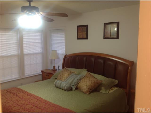 7129 Spanglers Spring Way Raleigh, NC 27610 - Photo 12 of 19 a bedroom with a bed and a window
