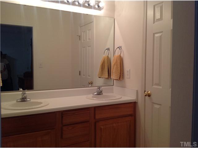 7129 Spanglers Spring Way Raleigh, NC 27610 - Photo 13 of 19 a bathroom with a sink and a mirror