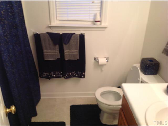7129 Spanglers Spring Way Raleigh, NC 27610 - Photo 15 of 19 a bathroom with a toilet and a sink