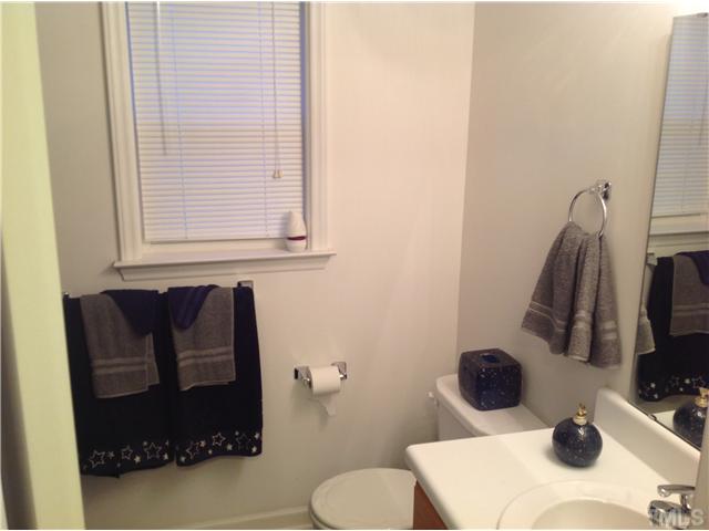 7129 Spanglers Spring Way Raleigh, NC 27610 - Photo 16 of 19 a bathroom with a sink and a mirror