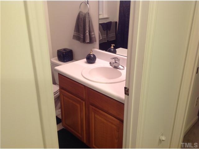 7129 Spanglers Spring Way Raleigh, NC 27610 - Photo 17 of 19 a bathroom with a sink and a mirror