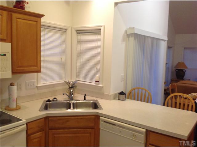 7129 Spanglers Spring Way Raleigh, NC 27610 - Photo 5 of 19 a kitchen with a sink and cabinets