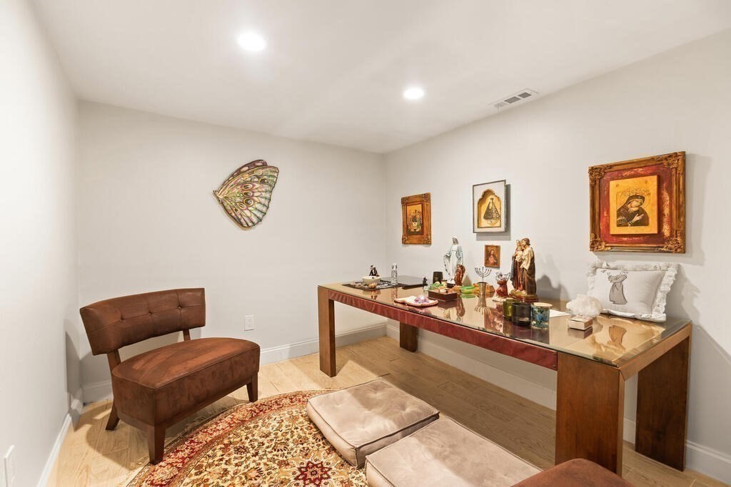 56 Clearwater Road Brookline, MA 02467 - Photo 15 of 34 a living room with furniture a couch and paintings on the wall