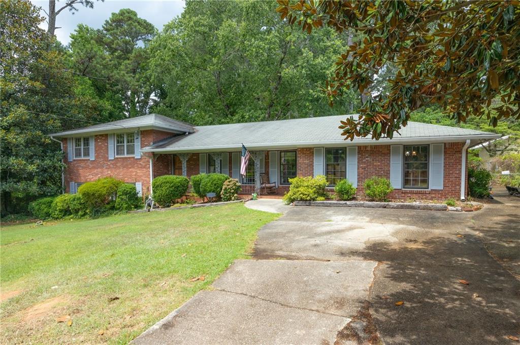 1645 Seayes Road Southwest Mableton, GA 30126 - Photo 1 of 1 a front view of a house with a garden