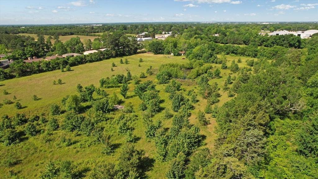 801 Jefferson Road Paris, TX 75460 - Photo 11 of 20 Aerial view of property with trees located in the interior and trees that line the perimeter of the property