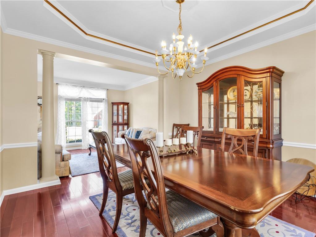 2354 Brentmoore Point Conyers, GA 30013 - Photo 15 of 91 a view of a dining room with furniture a chandelier and wooden floor