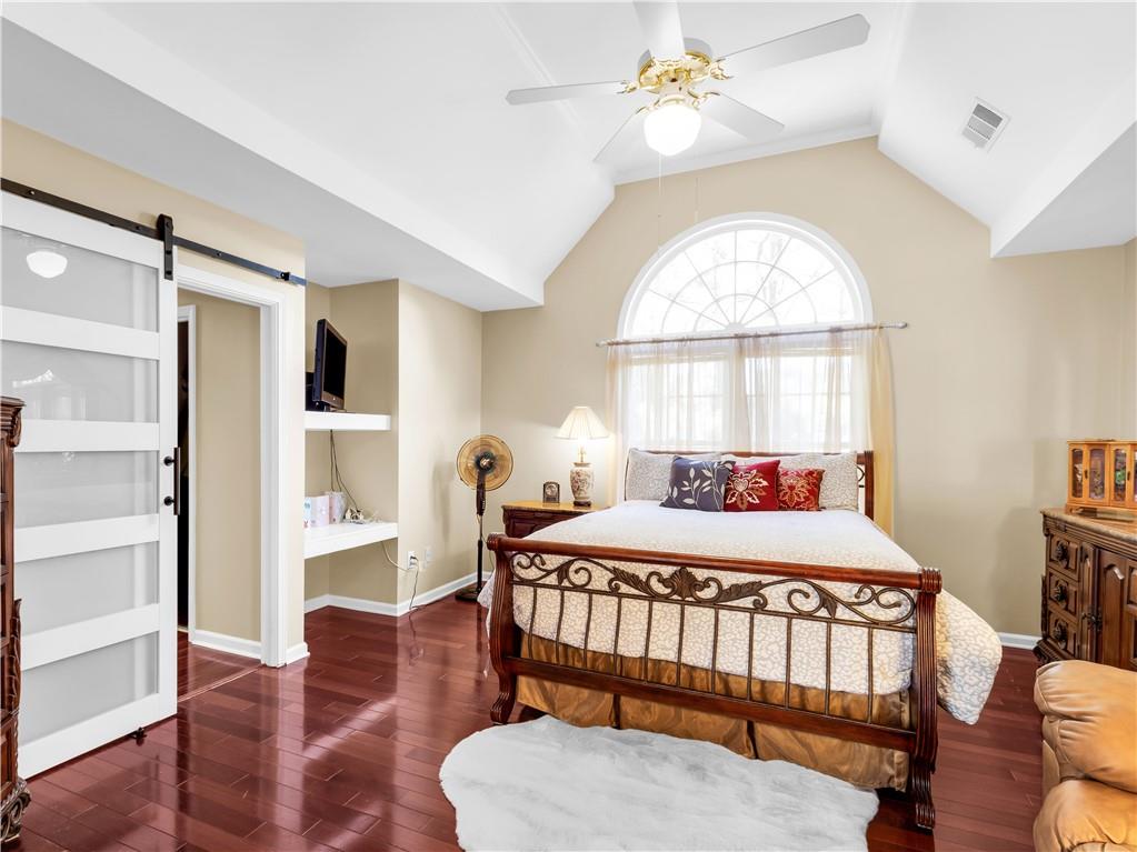 2354 Brentmoore Point Conyers, GA 30013 - Photo 35 of 91 a bedroom with a bed and a chandelier