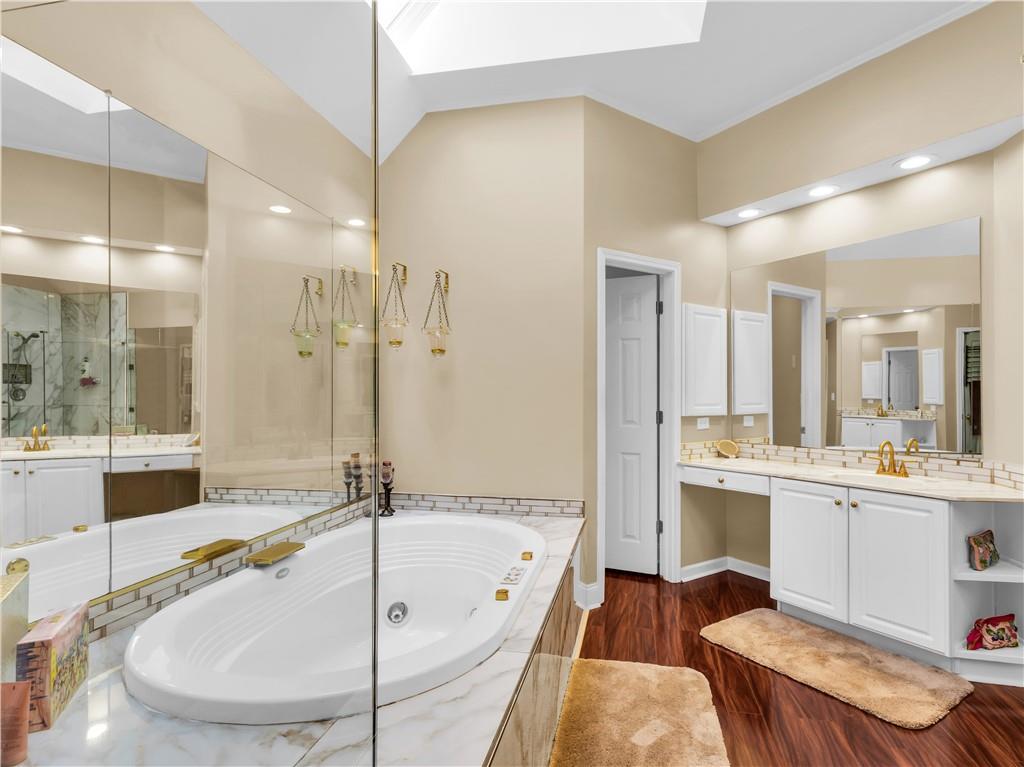 2354 Brentmoore Point Conyers, GA 30013 - Photo 43 of 91 a bathroom with a tub a sink and a large mirror