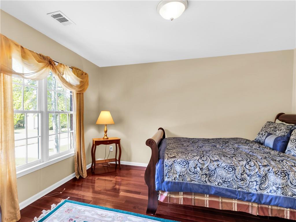 2354 Brentmoore Point Conyers, GA 30013 - Photo 50 of 91 a bedroom with a bed and wooden floor