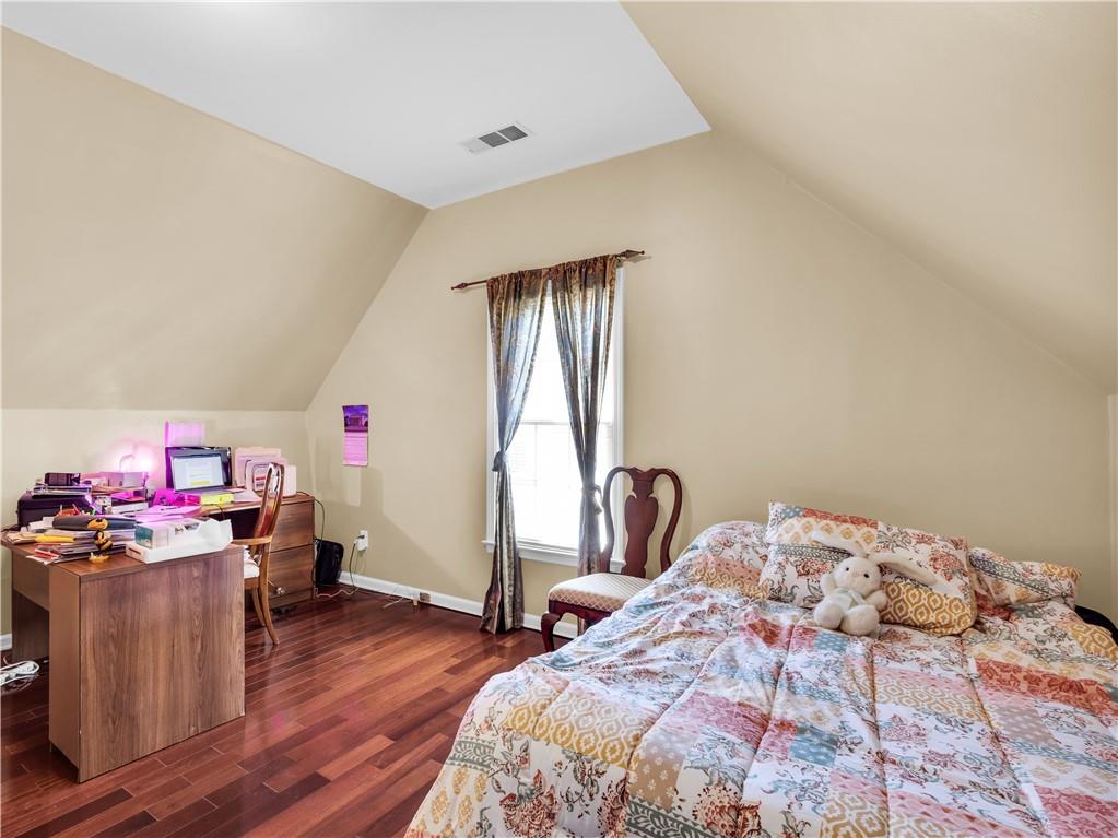 2354 Brentmoore Point Conyers, GA 30013 - Photo 60 of 91 a bedroom with a bed and wooden floor