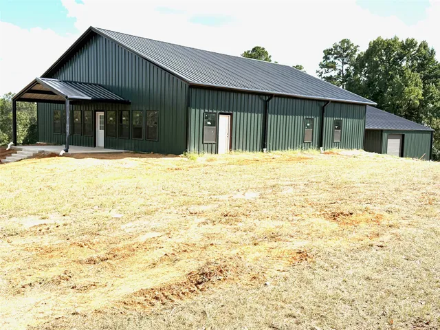 a backyard of a house with barbeque oven