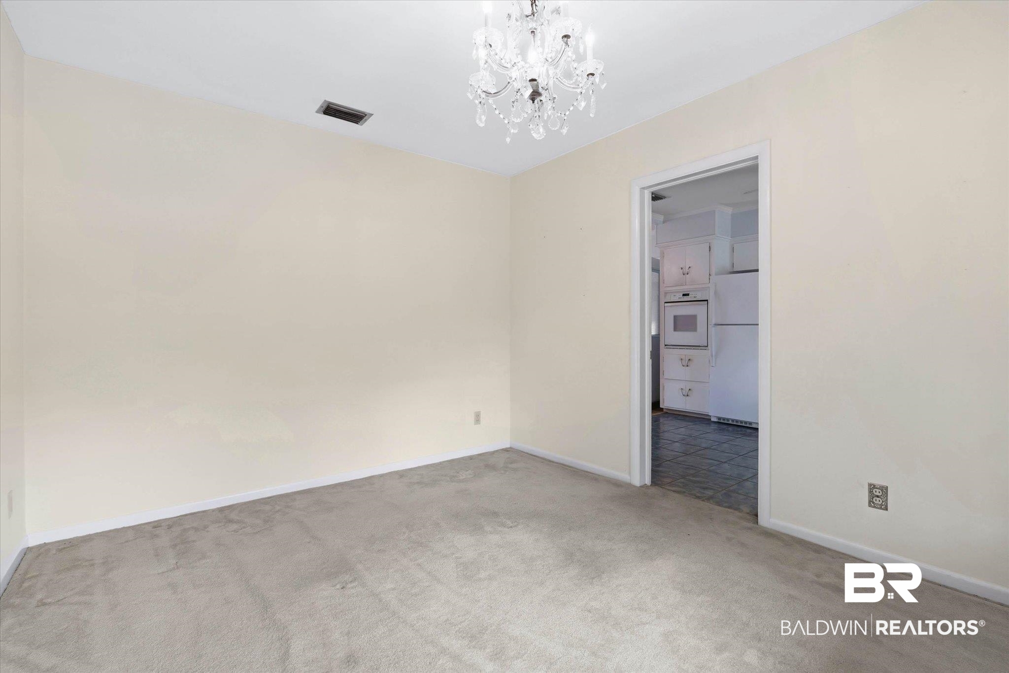 1182 Ginger Drive Mobile, AL 36693 - Photo 7 of 37 Neutral-toned room featuring a crystal chandelier and light grey carpet flooring