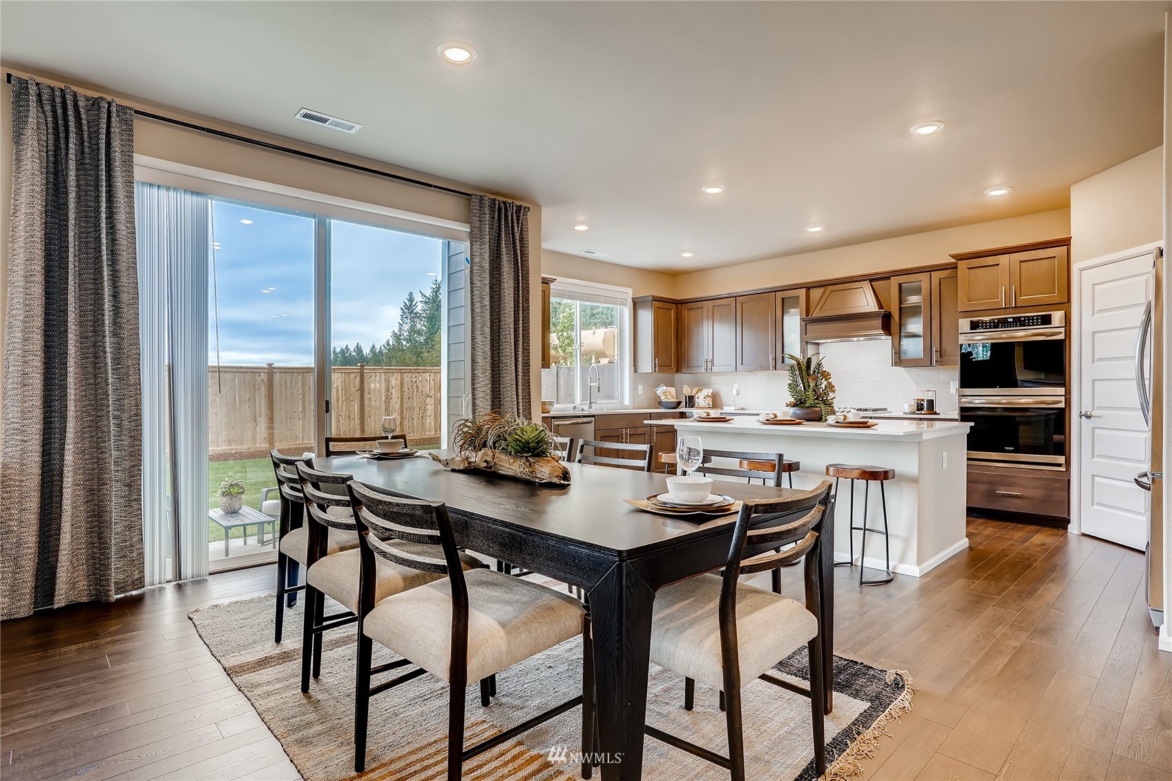 23518 41st Drive Southeast, Unit 53 Bothell, WA 98021 - Photo 9 of 24 a view of a dining room with furniture window and wooden floor