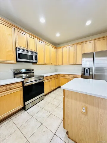 a view of empty room with wooden floor and fireplace