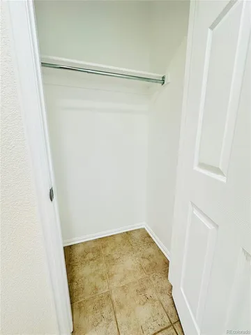 a view of a hallway with stairs and wooden floor