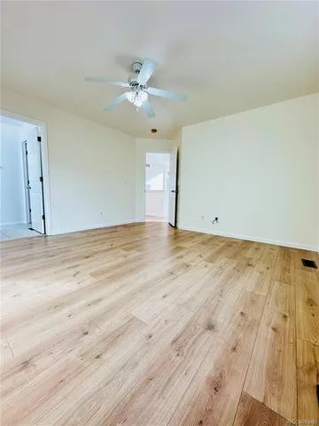 a view of a room with wooden floor
