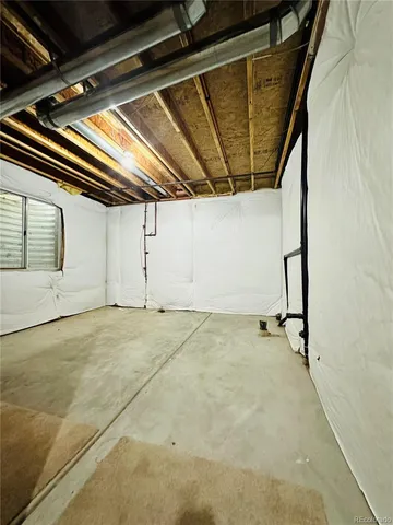 a backyard of a house with plants and large garden