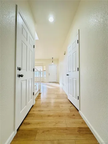 a view of a room with wooden floor