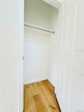 a large kitchen with a large window and stainless steel appliances